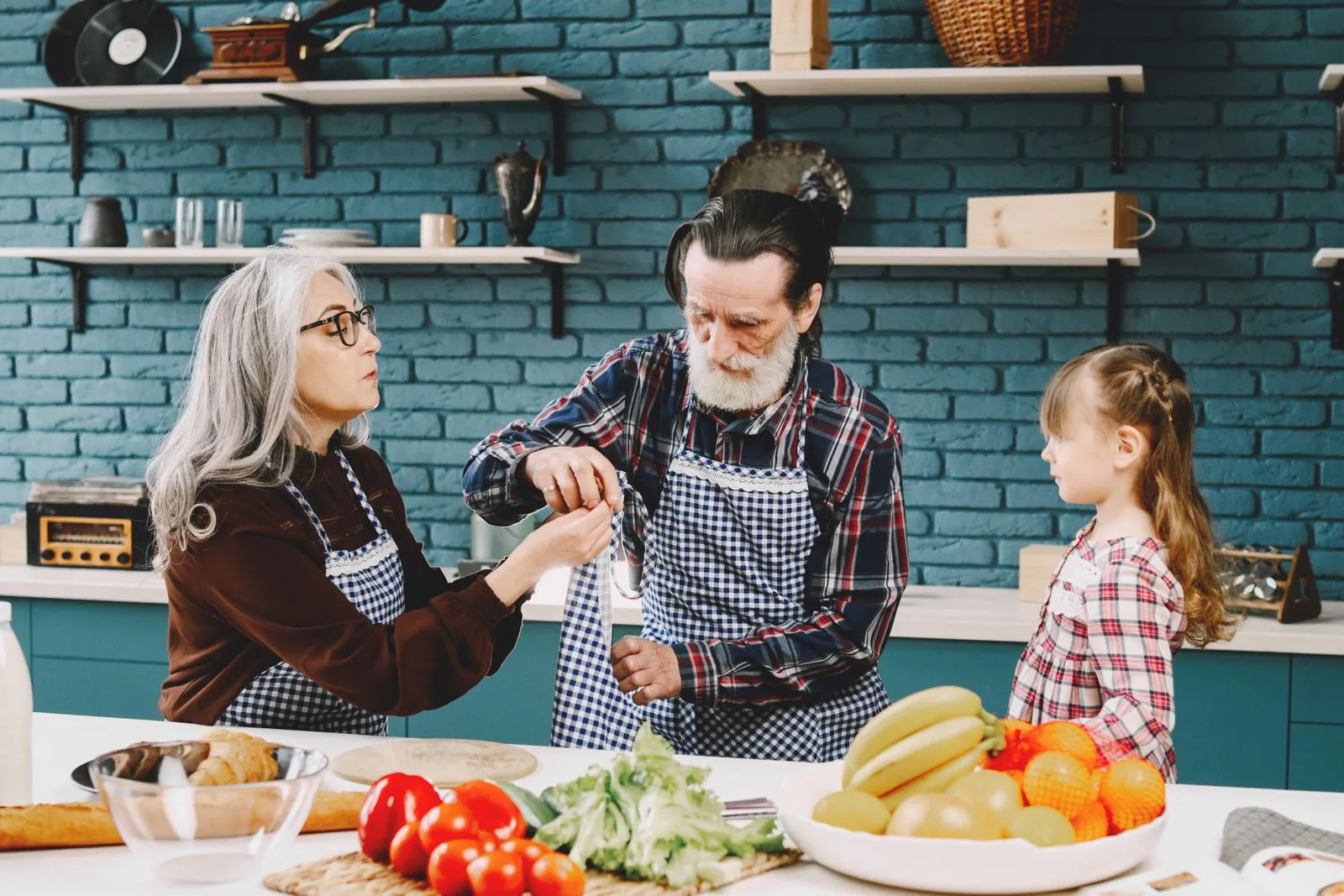 Senior couple and grandchild bonding over cooking in a cozy kitchen setting, enjoying quality time together.